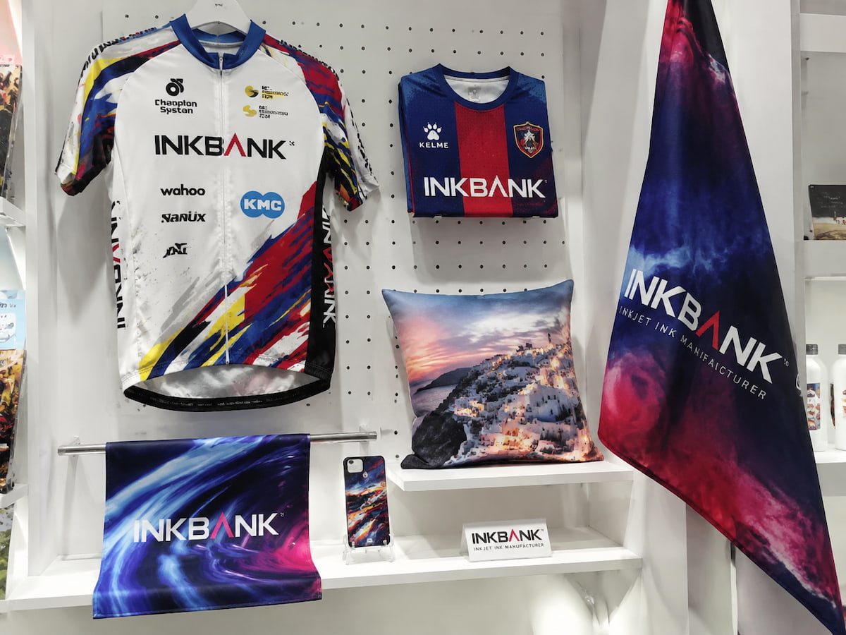 INKBANK sublimation ink finished product sample wall — cycling jersey, football shirt, soft signage banner, phone case, flag, cushion cover printed with INKBANK sublimation ink
